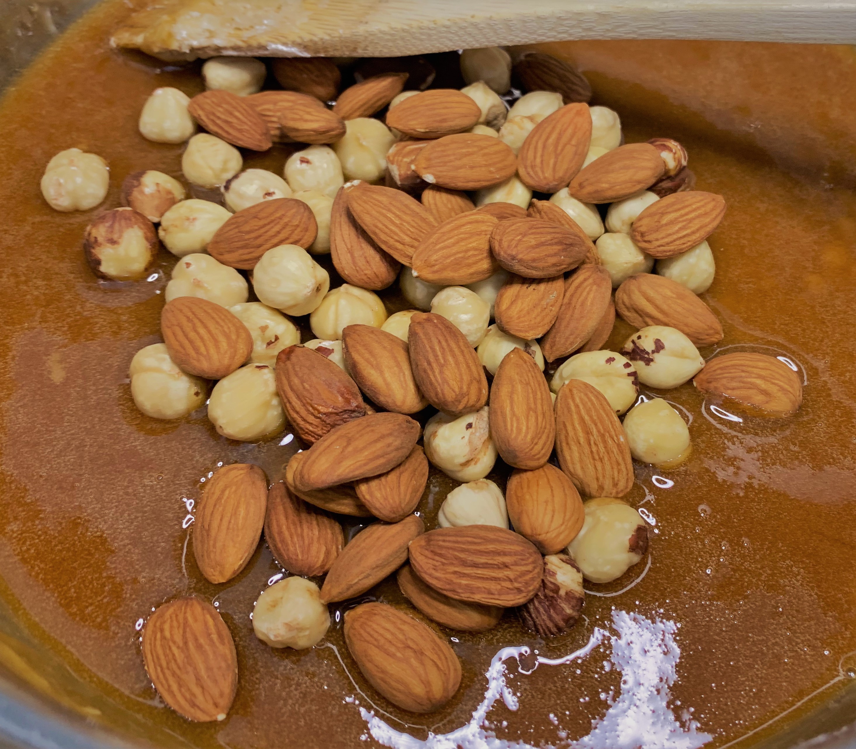 Adding the nuts to the caramel for our Praline Paste