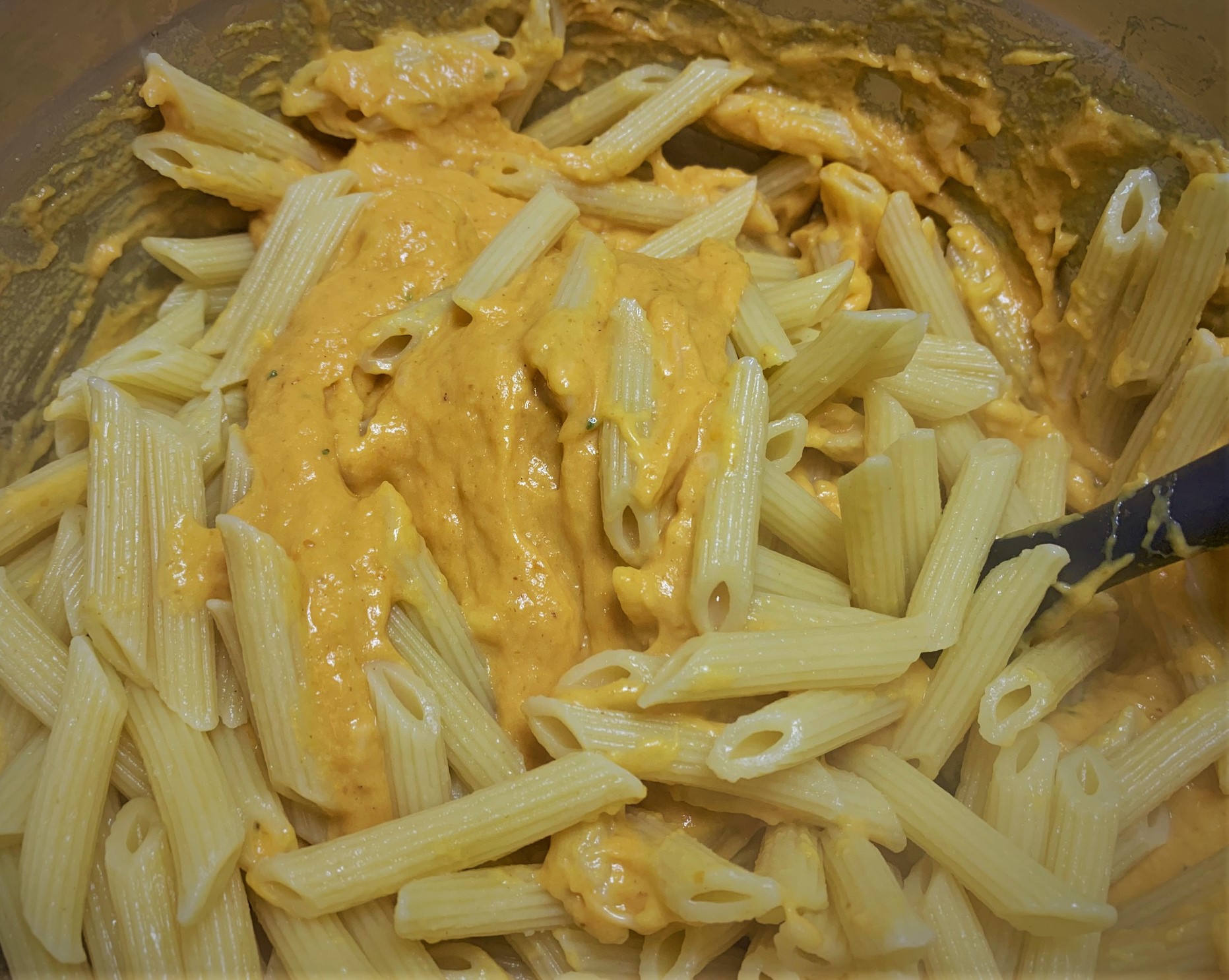 Adding the pasta to our Pumpkin Mac & Cheese