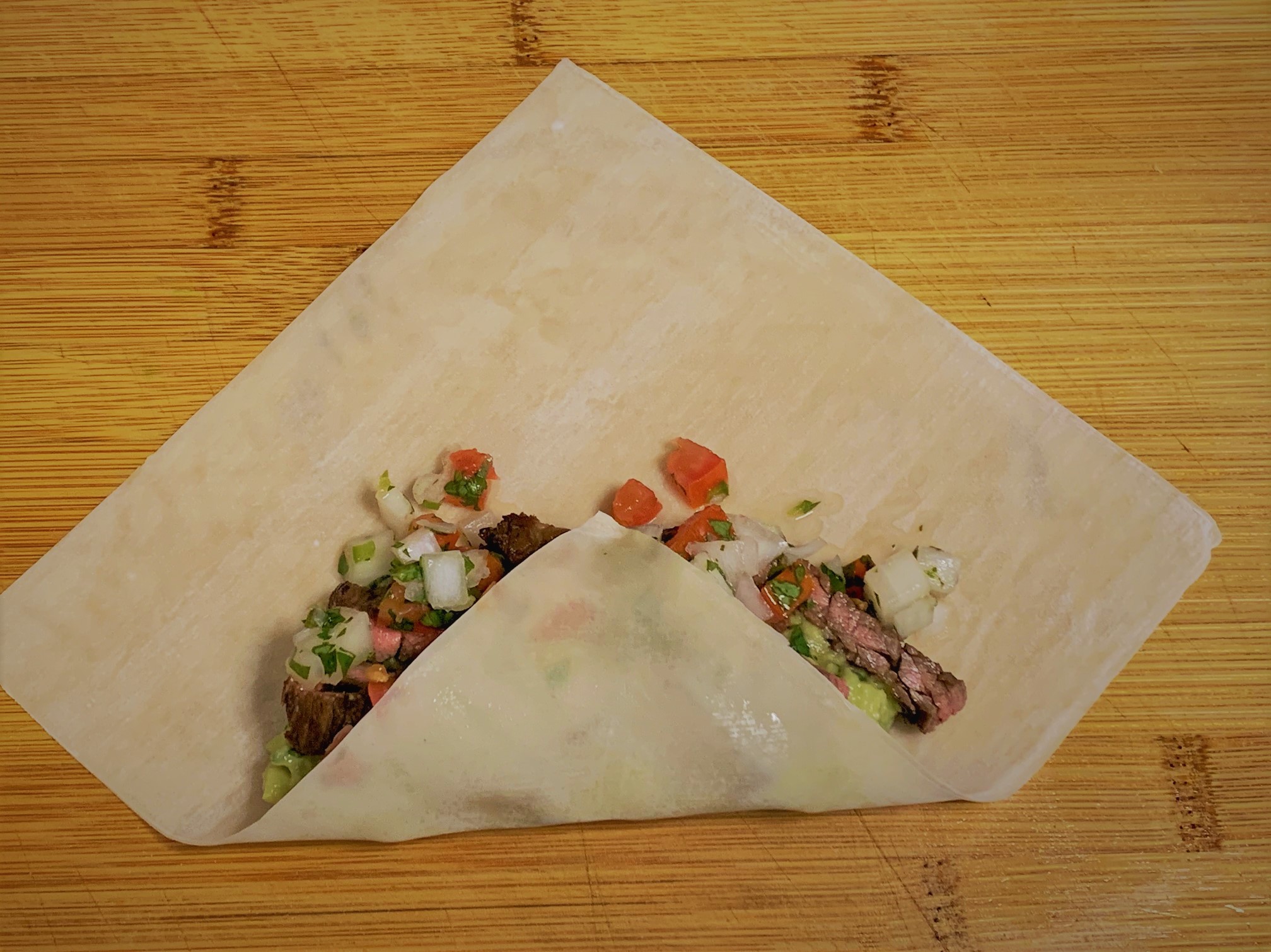 The first fold of our Carne Asada Spring Rolls