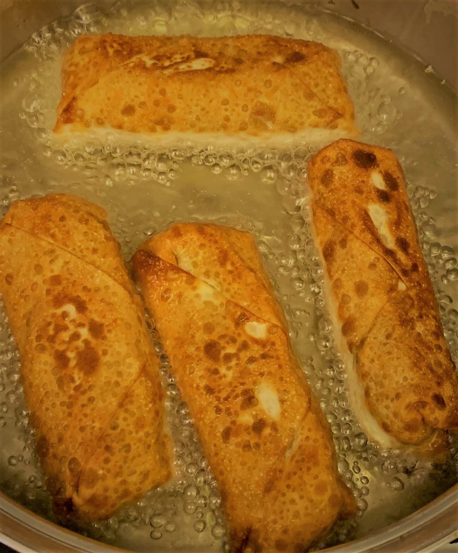 Frying our Carne Asada Spring Rolls