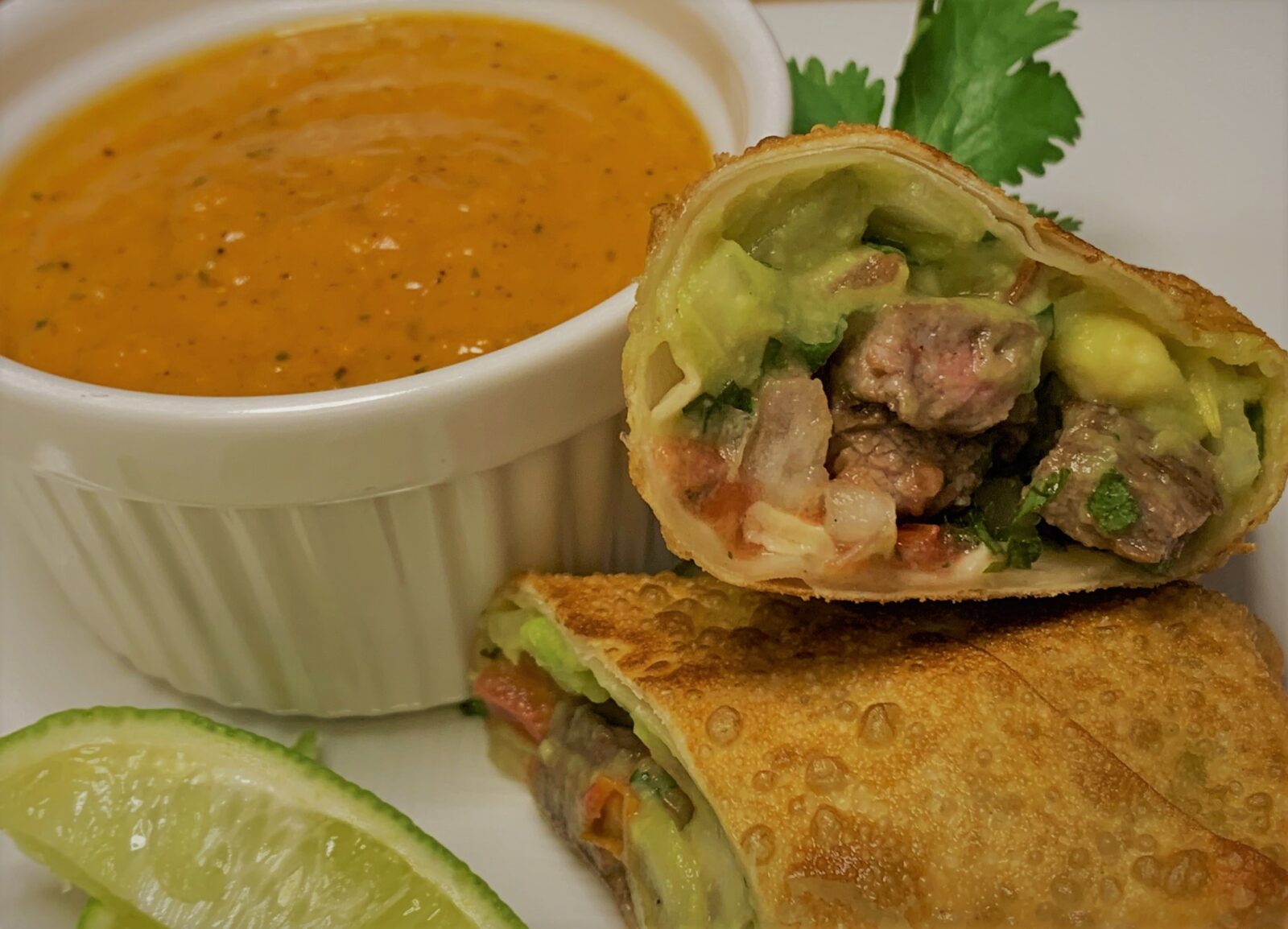 Our plated Carne Asada Spring Rolls with Fire Roasted Tomato Salsa