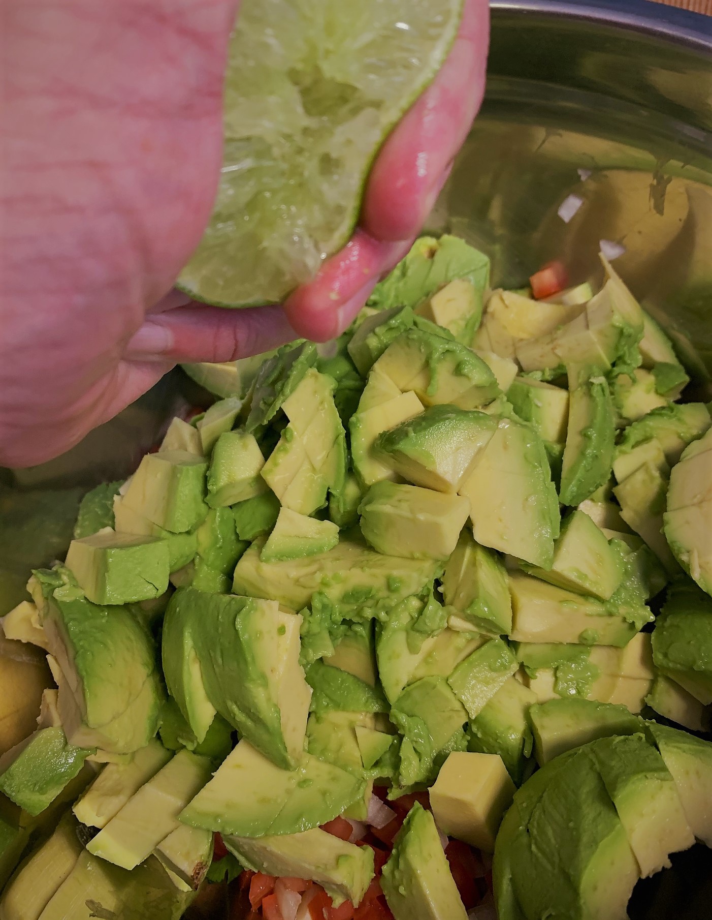 Adding our Fresh Lime Juice to our Traditional Guacamole