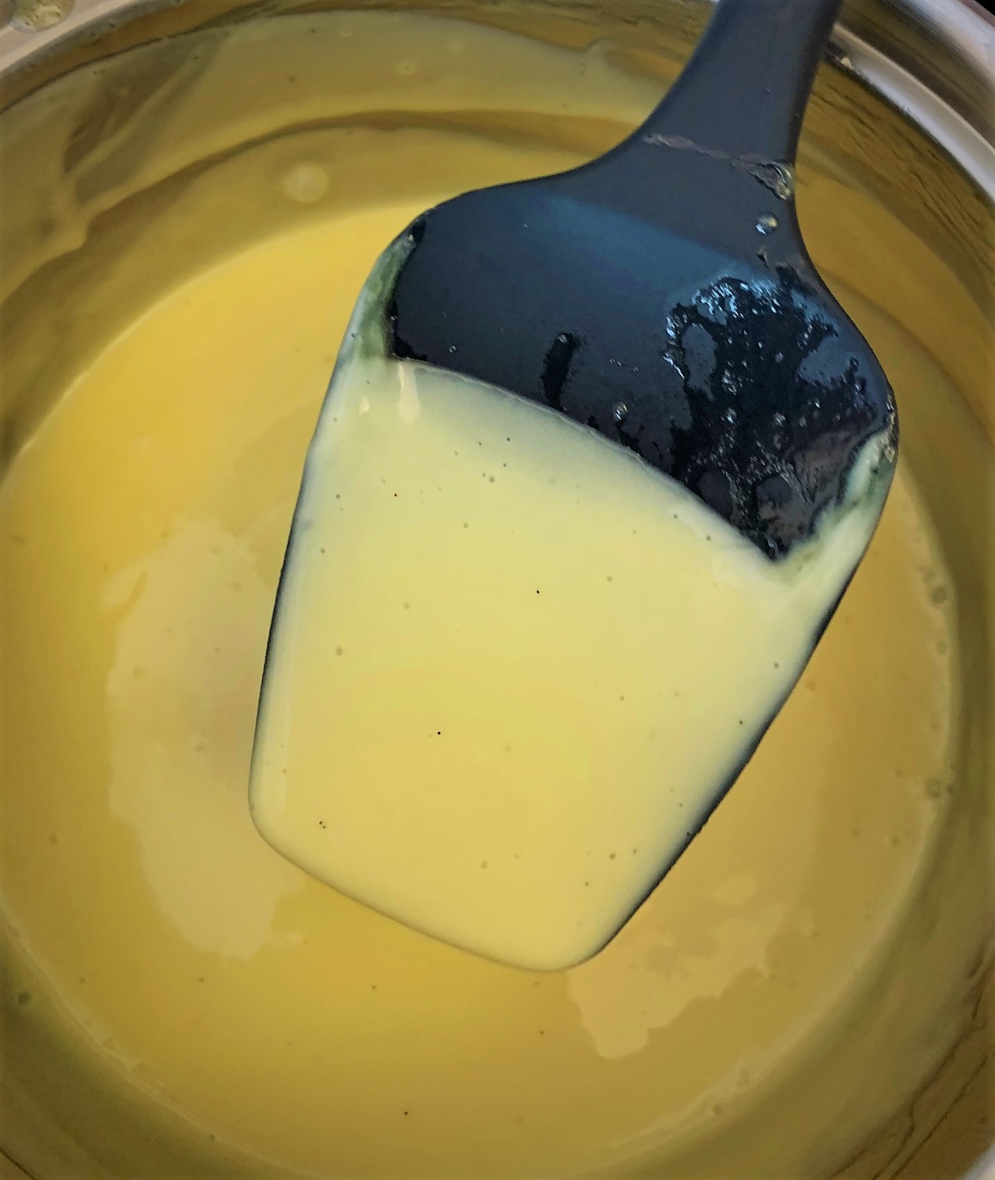 Our Vanilla Sauce coating the back of a spoon