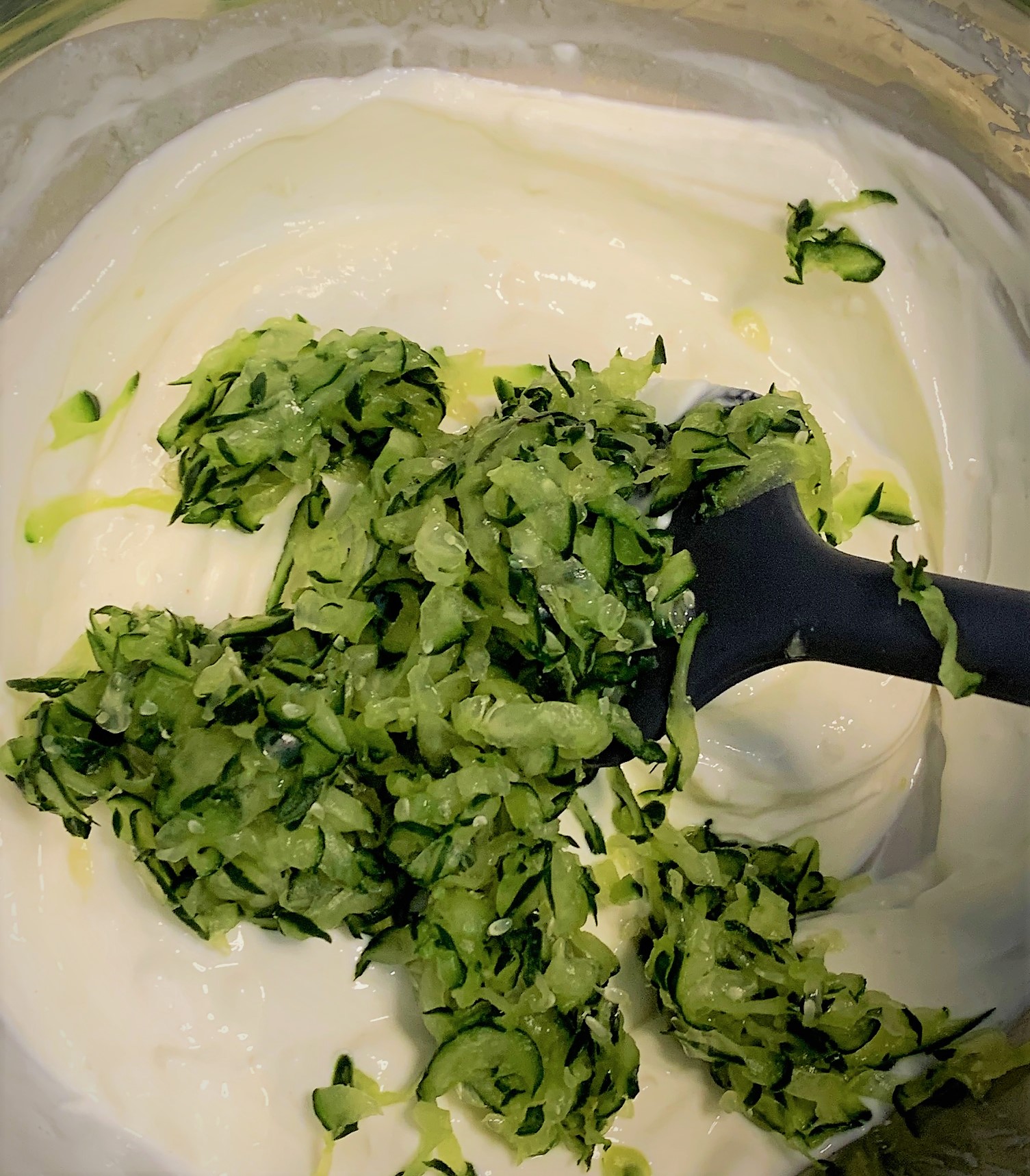 Adding the Shredded Cucumber to the Creamy Peppercorn Sauce for our Ronto Wrap Copy-Cat Recipe