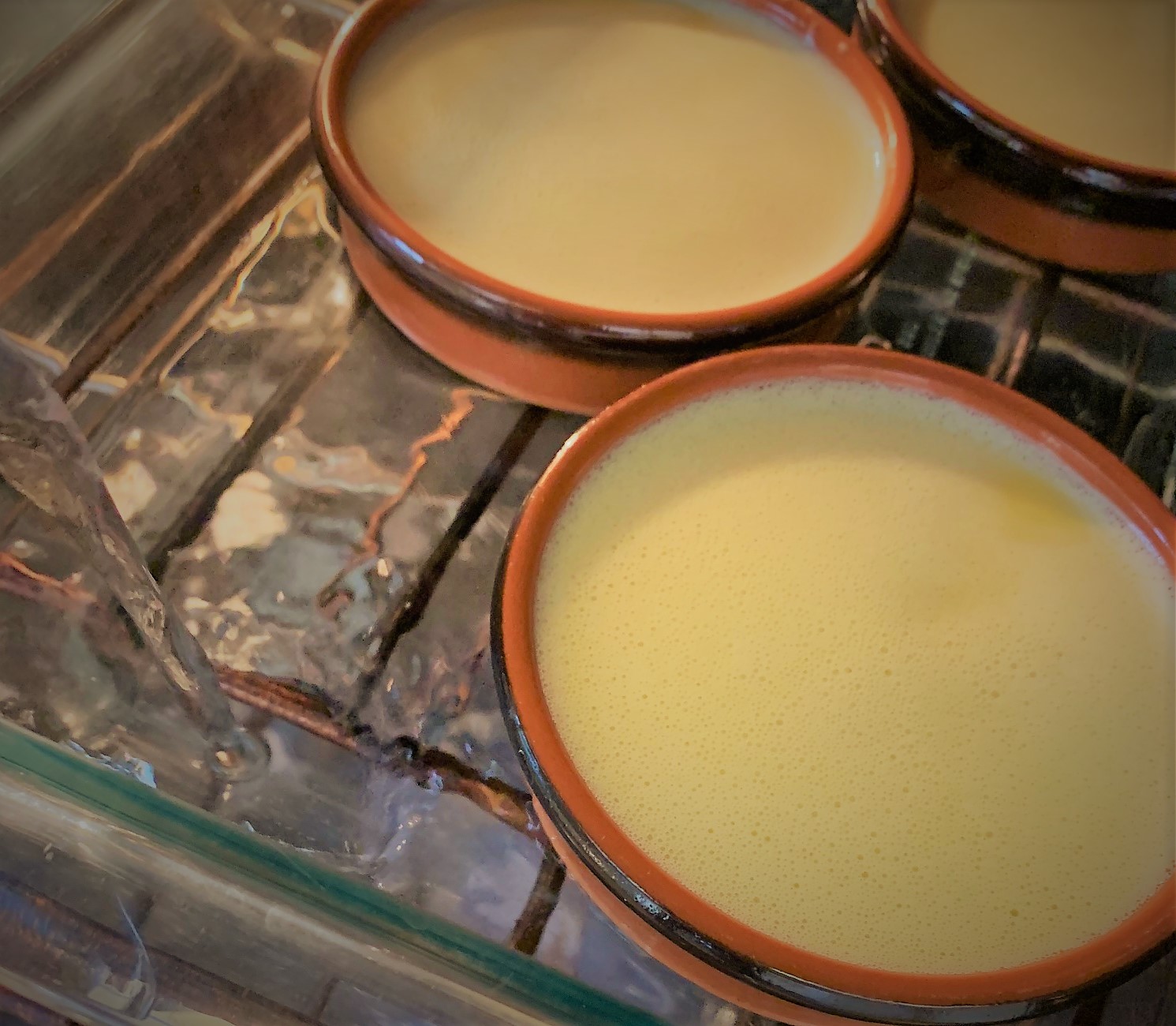 Adding the water to the baking dish with our Maple Creme Brûlée in the oven