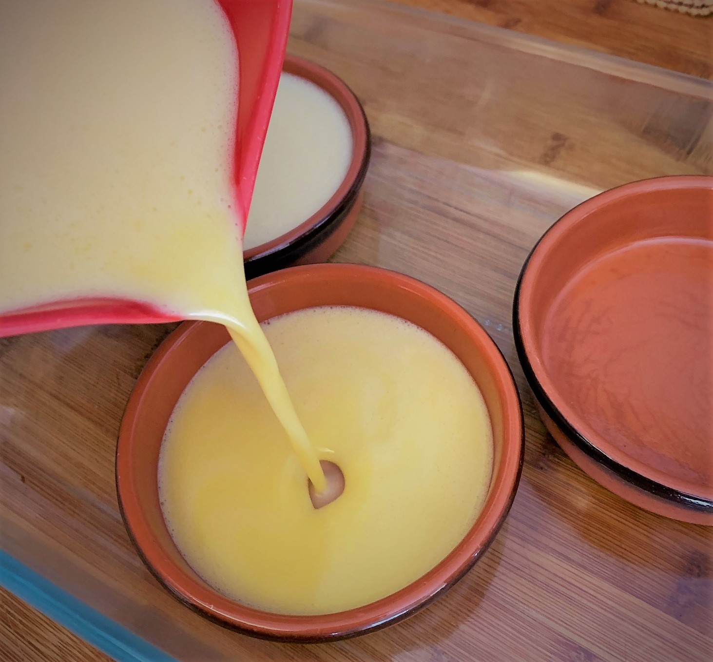 Adding our mixture to the baking dishes