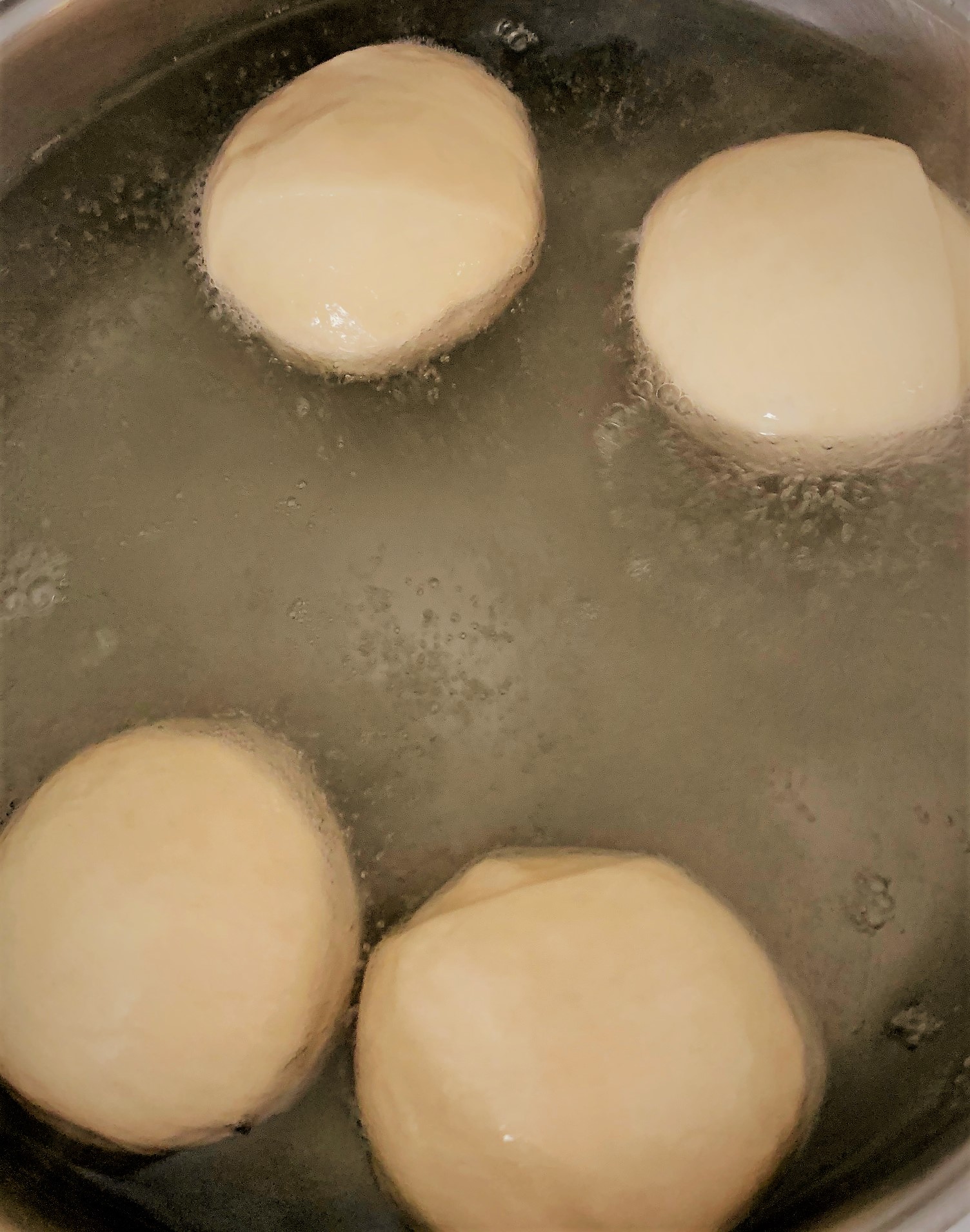 Boiling our Pretzel Slider Rolls before baking