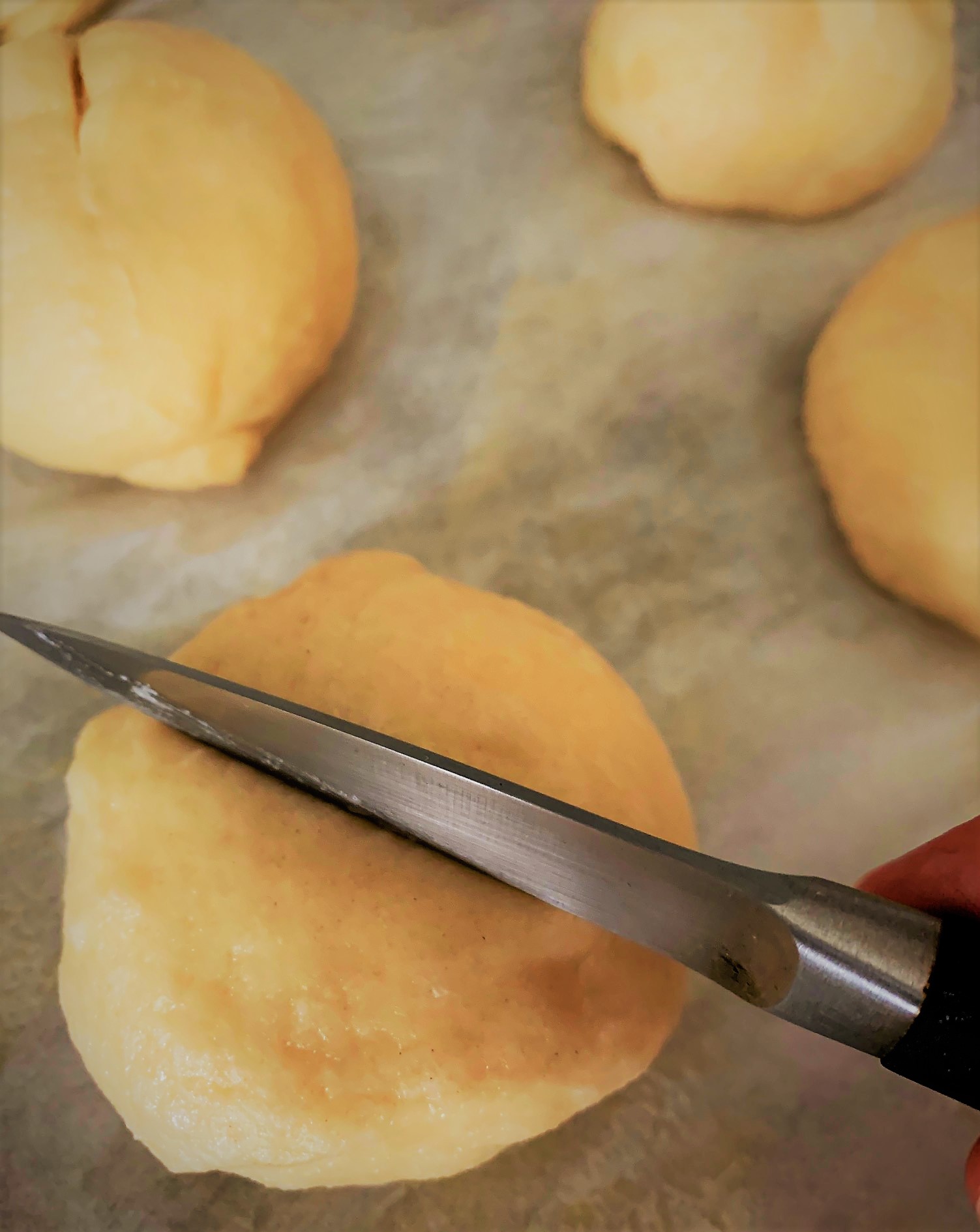 Cutting an "x" into our Pretzel Slider Rolls