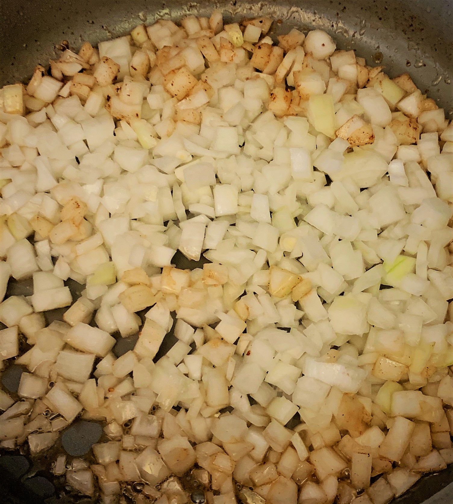 Onions in the heated pan for our Braised Short Rib Sliders