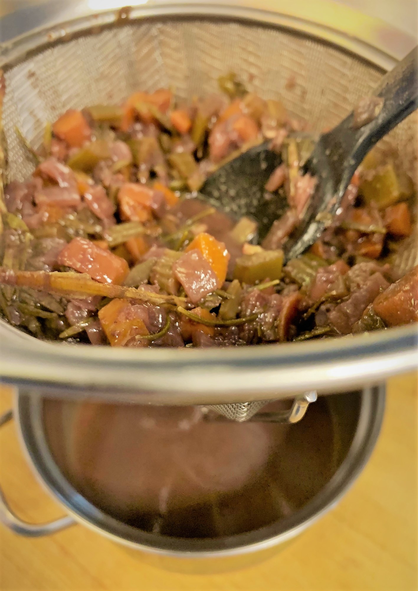 Straining the Braising Liquid for our Braised Short Rib Sliders