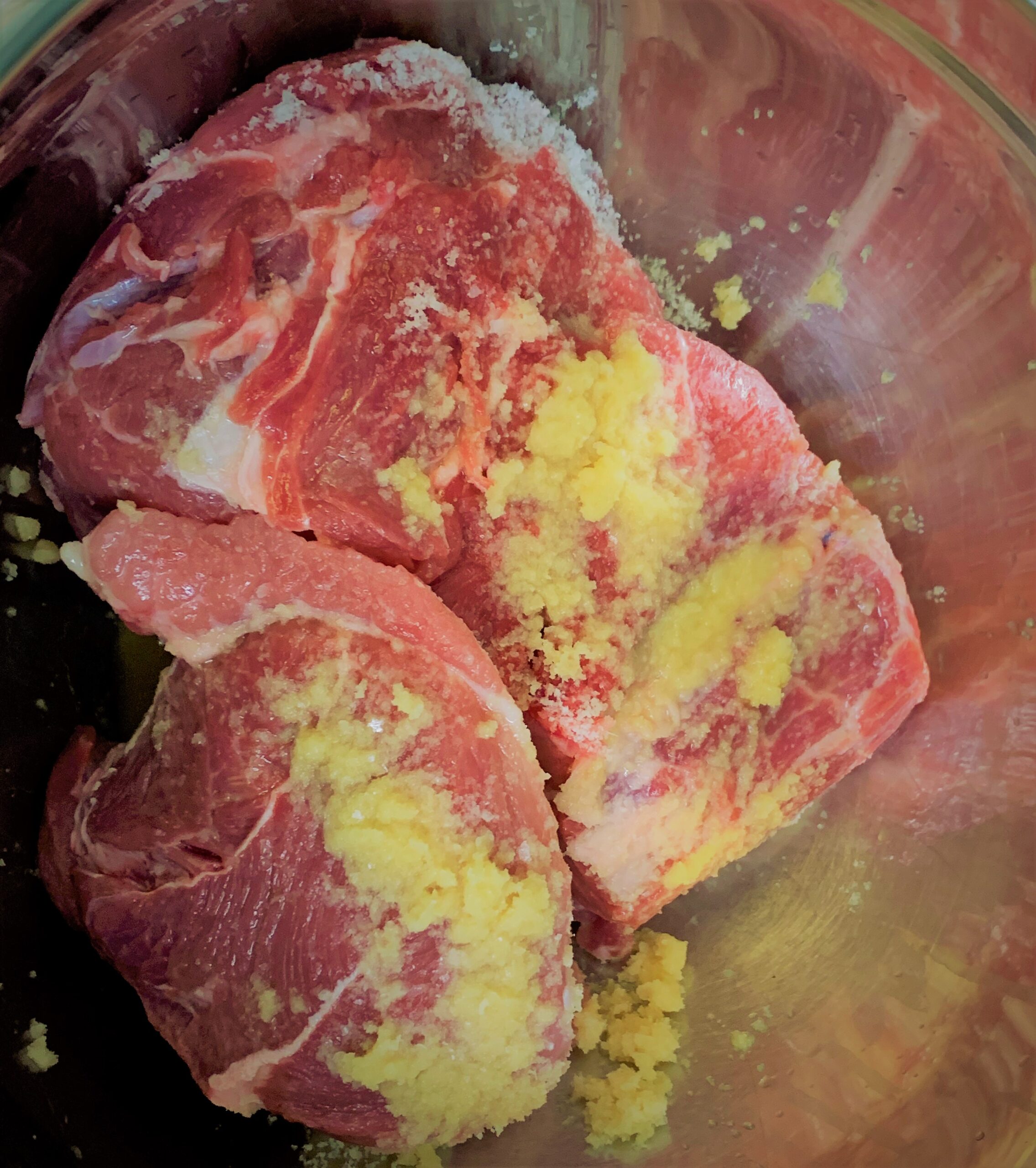 Seasoning the meat for our Kalua-Style Pulled Pork Tots with Polynesian BBQ Sauce & Mango Salsa