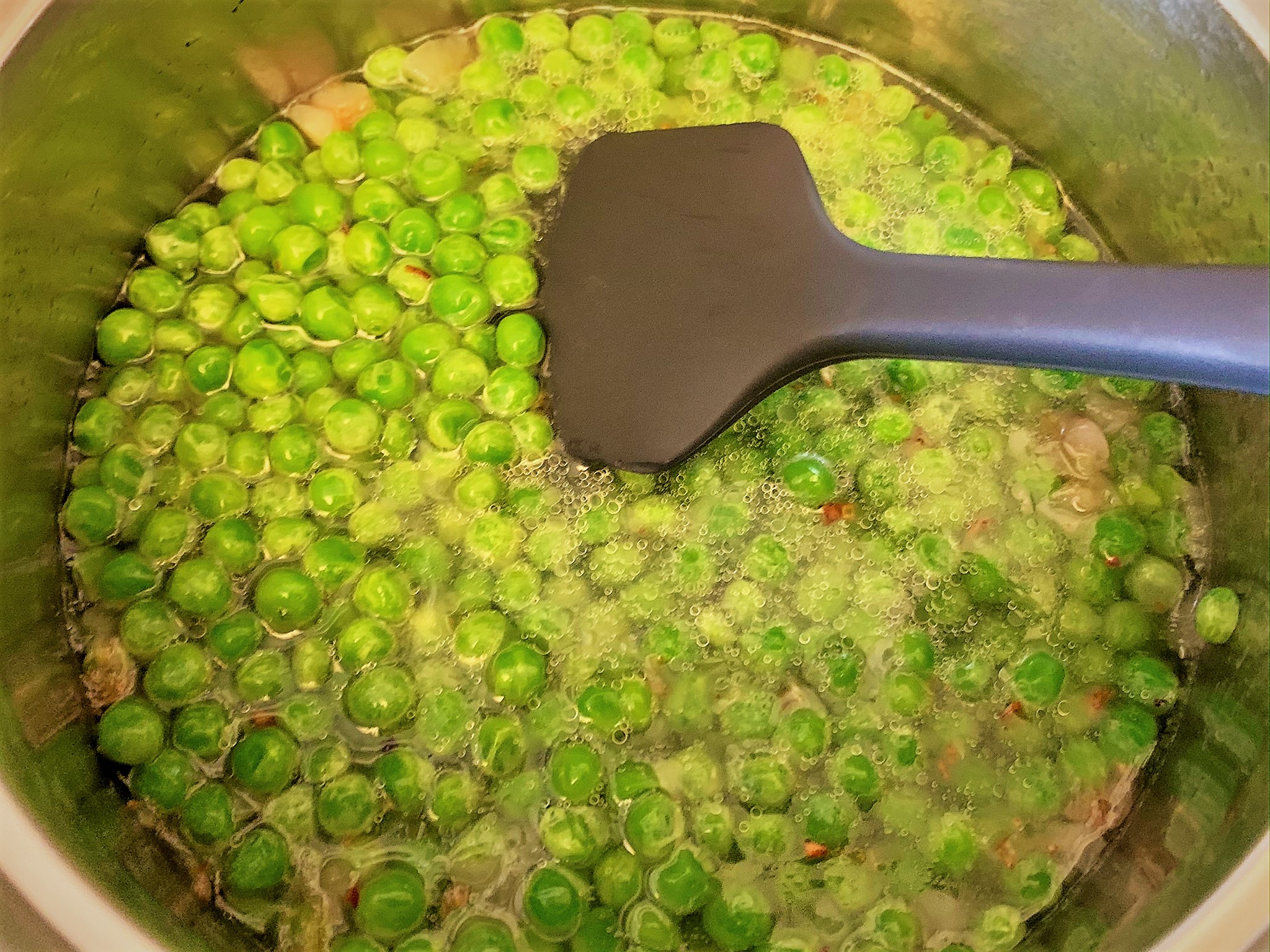 The simmering mixture for our Minted Pea Puree - Pancetta Seared Scallops with Crispy Prosciutto & Minted Pea Puree