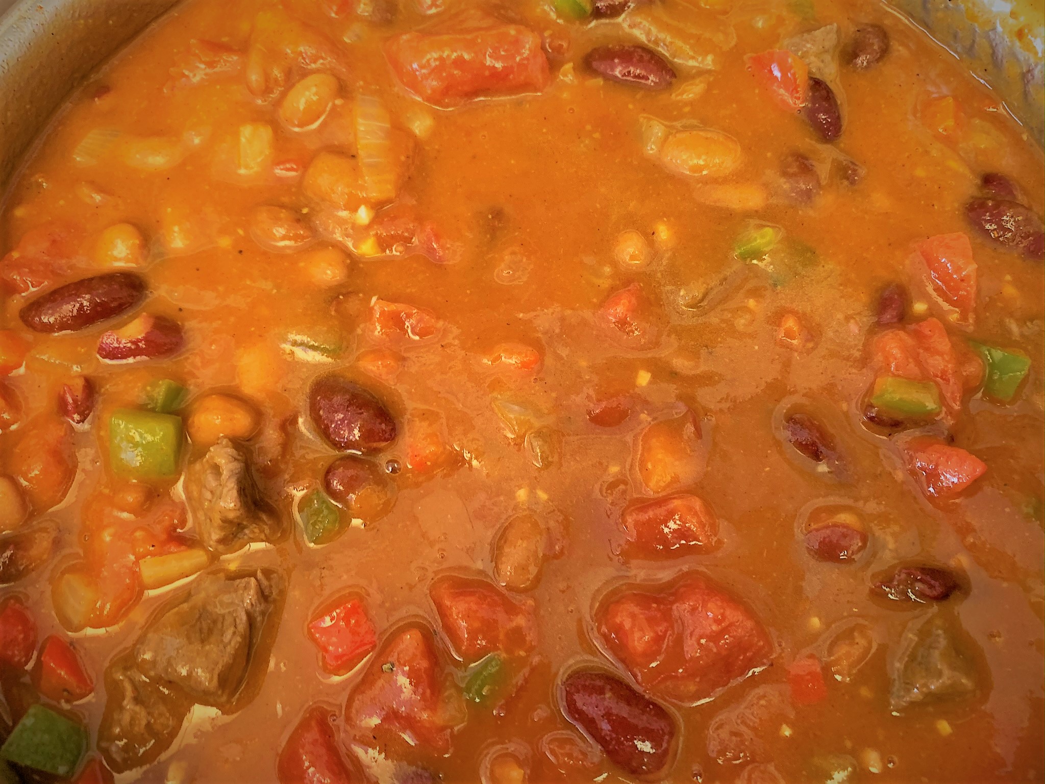 Adding the stock to our Pumpkin Chili Recipe