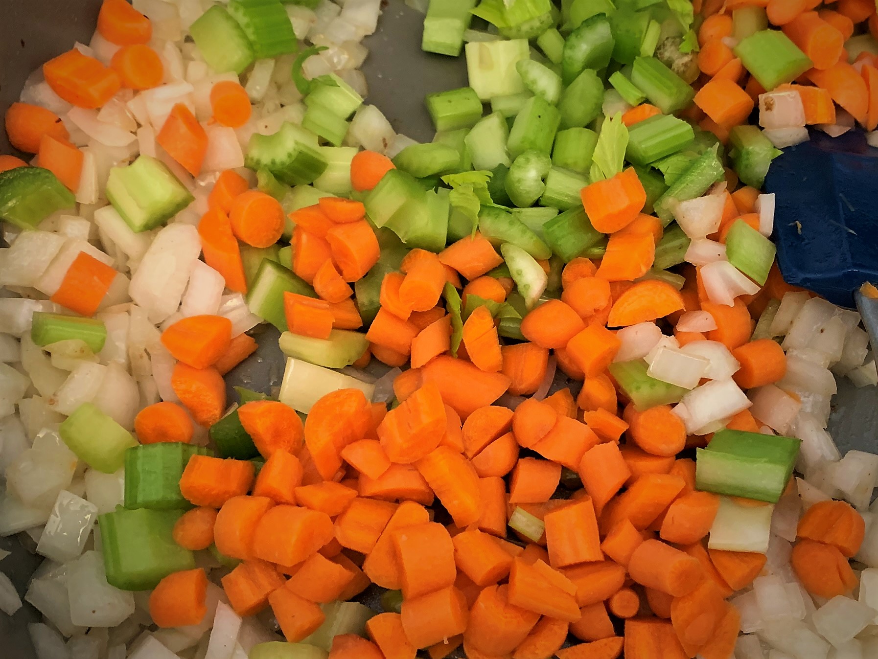 Adding Onions, Carrots and Celery to the hot pan 