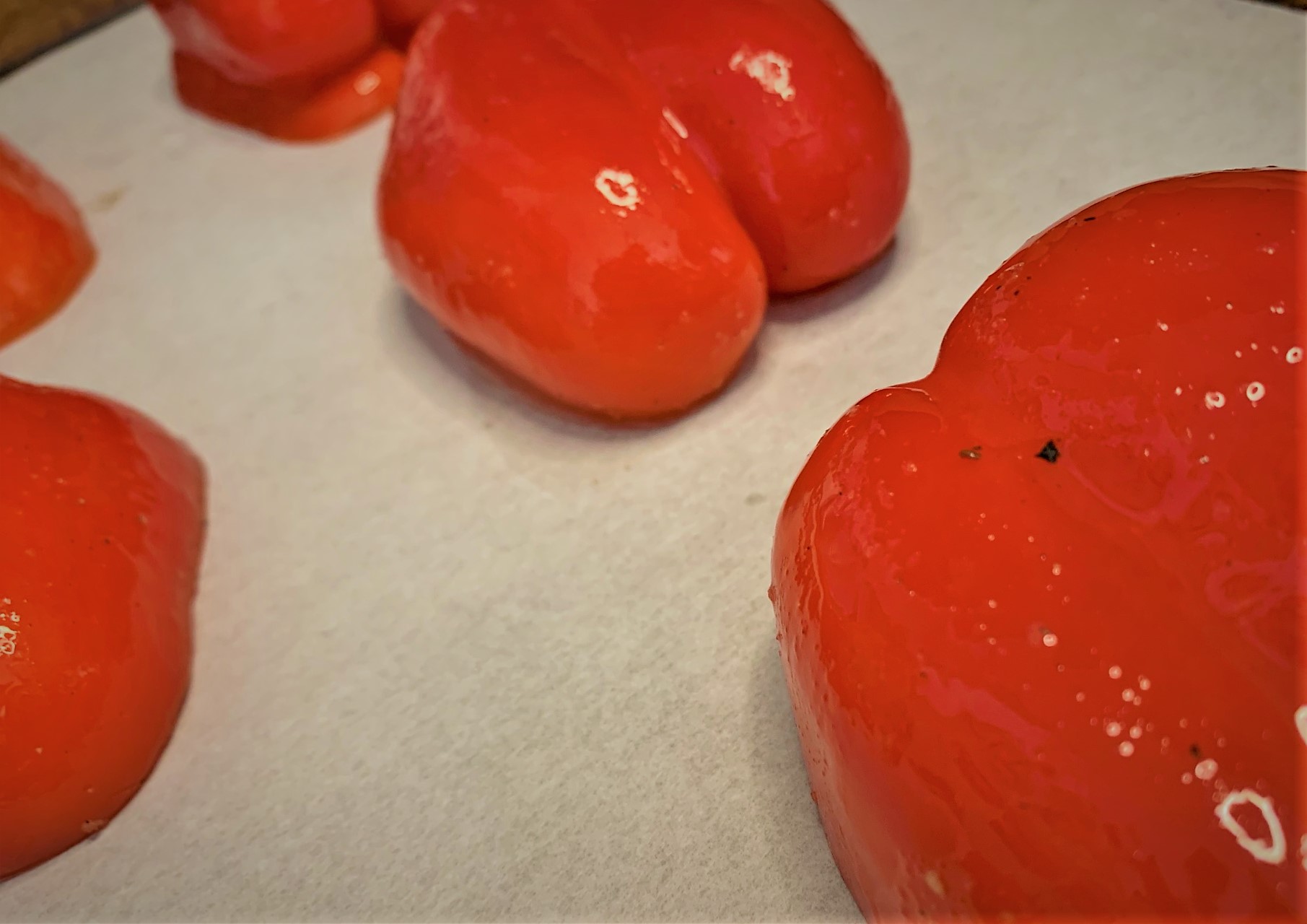 Red Bell Peppers seasoned and ready to be roasted for our Red Pepper Coulis