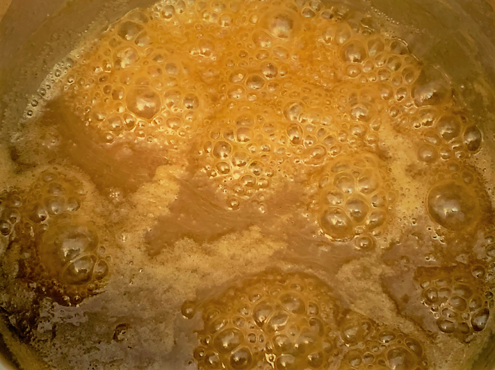 Bubbling Caramel Sauce for our Boma French Toast Bread Pudding with Pecan Praline Sauce