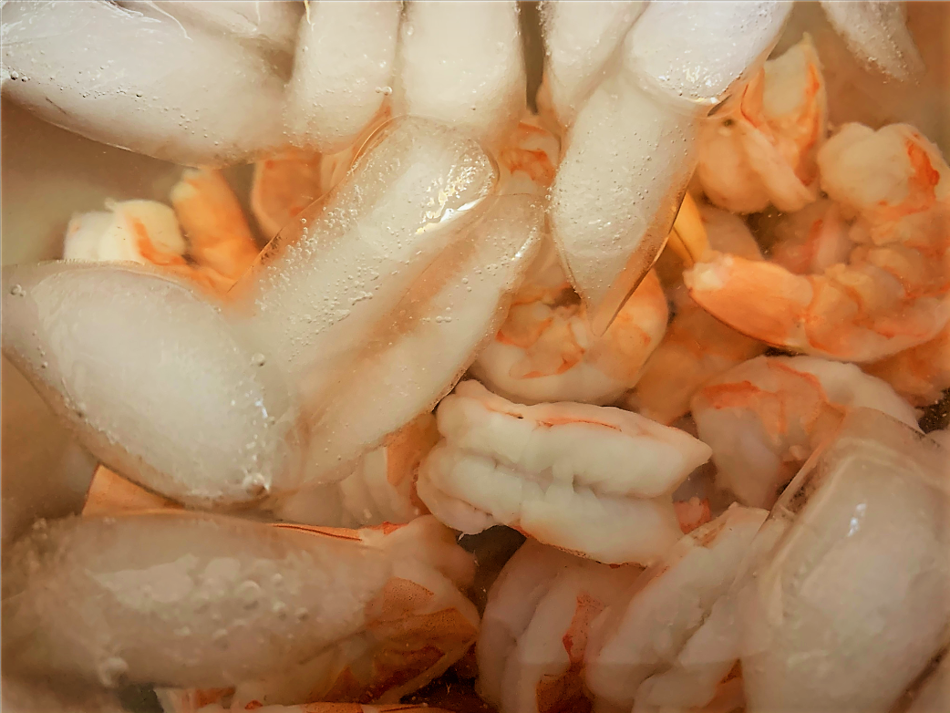 Our Shrimp in a bowl filled with ice-water after par-cooking