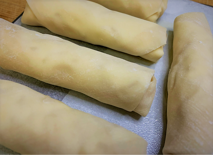 Our fully rolled Pongu Lumpia lined up on a baking sheet and ready to go in the freezer