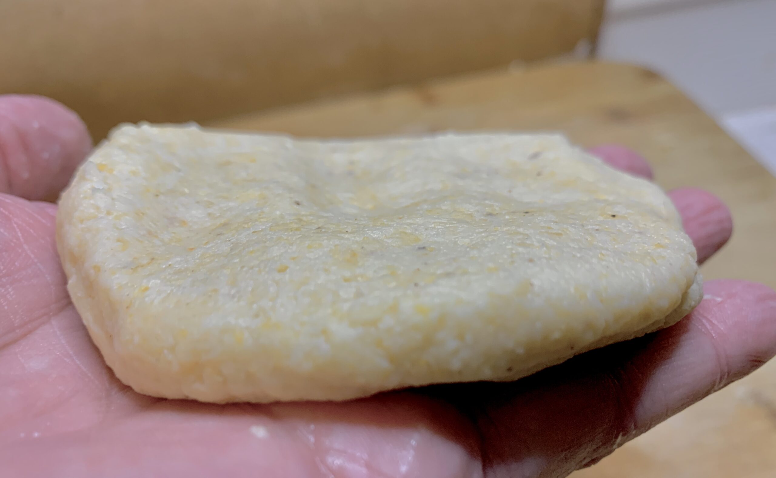 One of our formed Arepas ready for frying - Disney Dishes Arepas con Queso Recipe - Inspired by Disney's Encanto