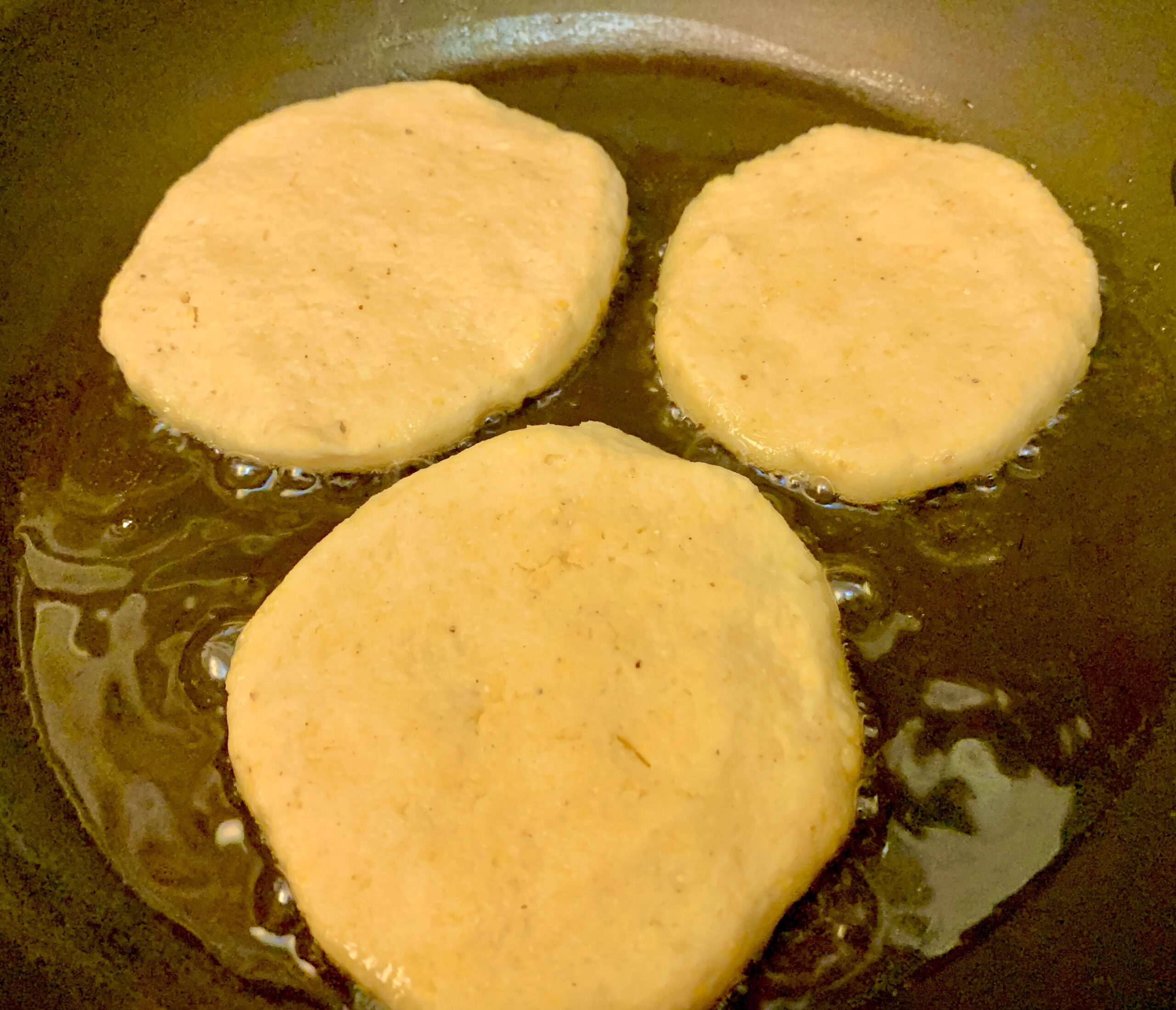 Frying the first side of our Arepas con Queso