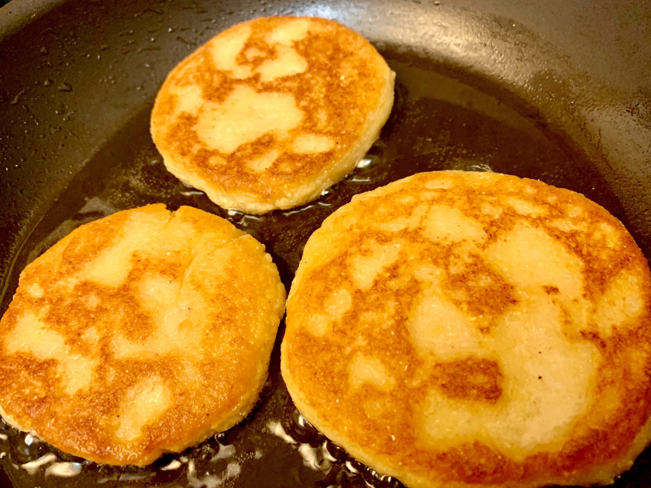 Frying the second side of our Arepas con Queso