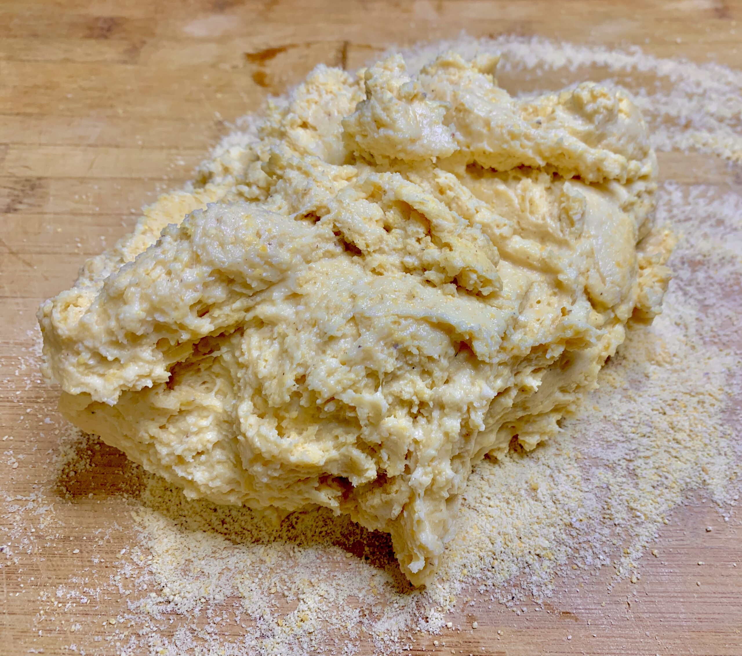 The dough turned out to a cutting board and ready for kneading - Disney Dishes Arepas con Queso Recipe - Inspired by Disney's Encanto