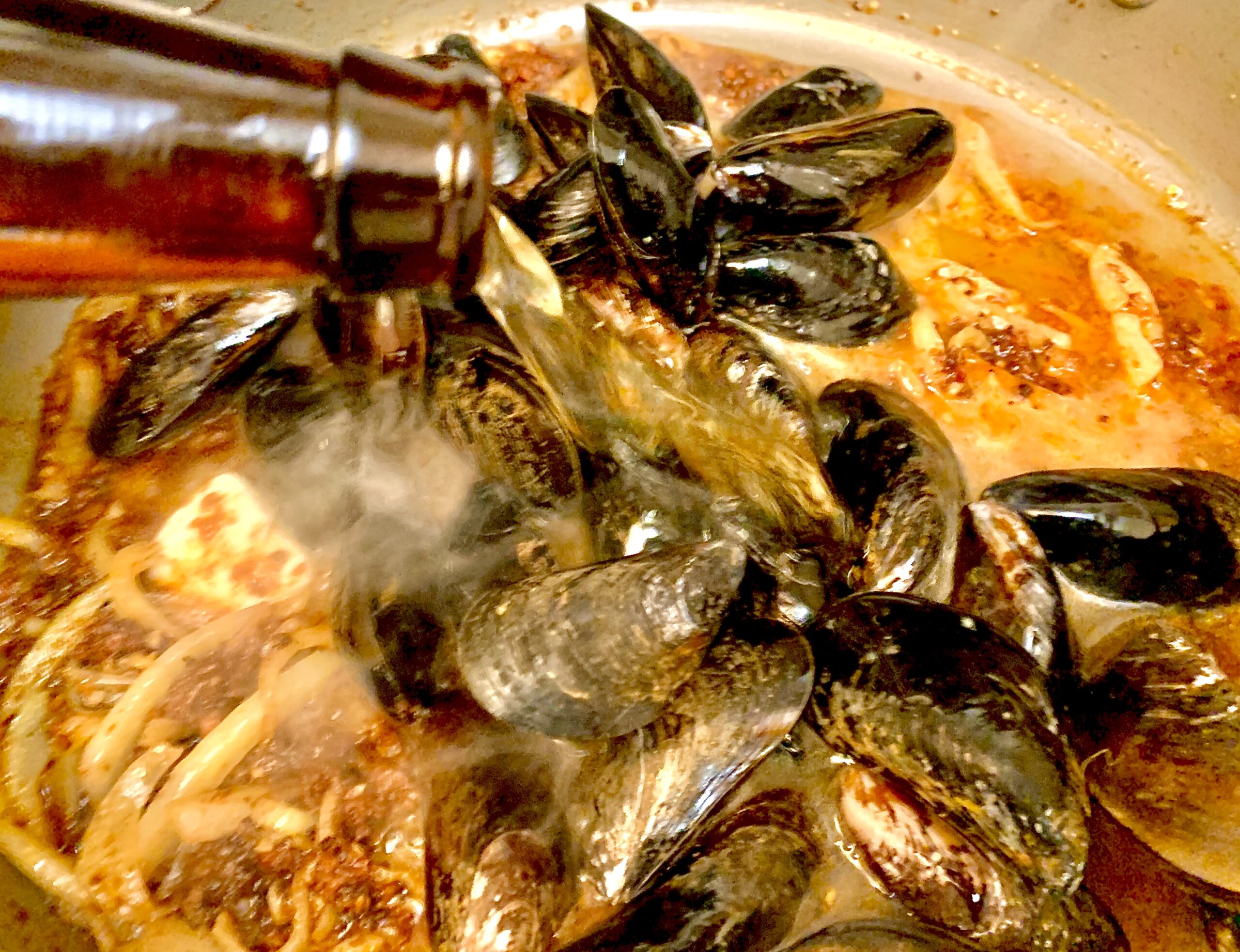 Mussels and Hard Cider added to the pan