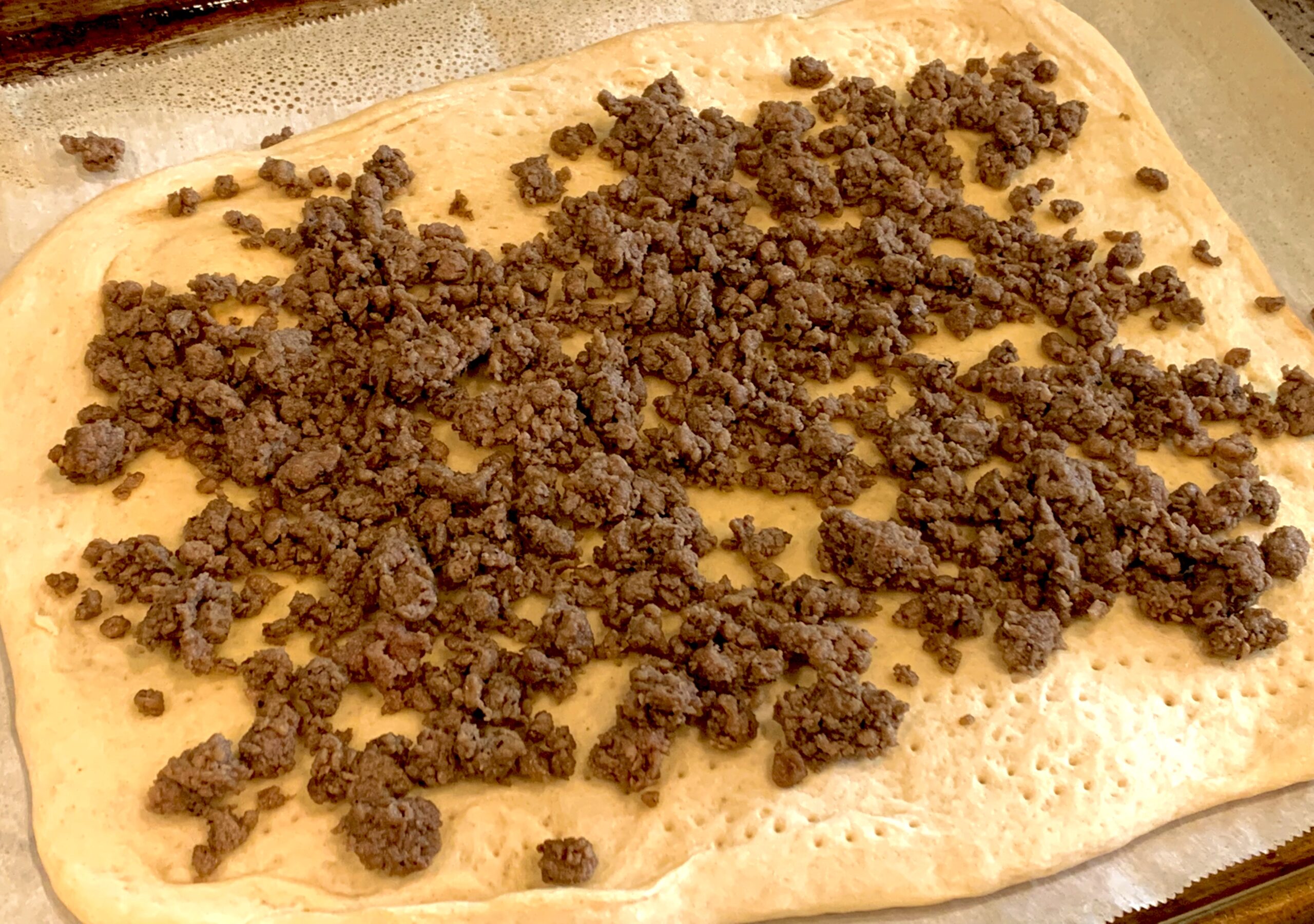 The seasoned "meat" on top of our partially cooked flatbread crust