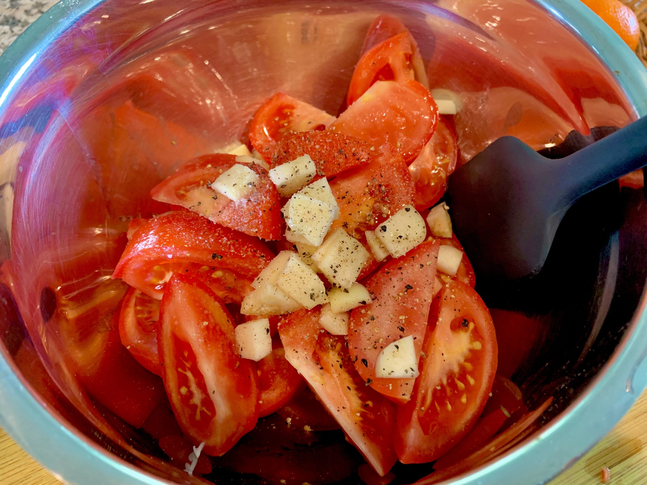 Tomatoes, garlic and seasonings in a bowl and ready for coating with olive oil - Cosmic (Plant) Power Flatbread